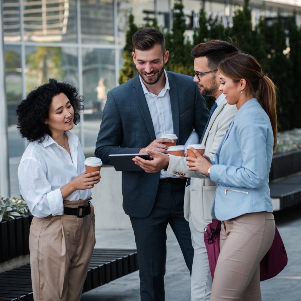 people smiling and looking at tablet